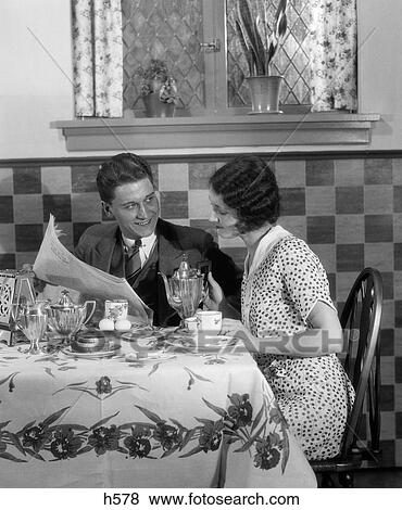 1920S 1930S Couple At Breakfast Table Looking Over Newspaper Wife Getting Ready To Pour Coffee From Silver Pot View Large Photo Image Stock Photo - 1920S 1930S Couple At Breakfast Table Looking Over Newspaper Wife Getting Ready To Pour Coffee From Silver Pot. Fotosearch