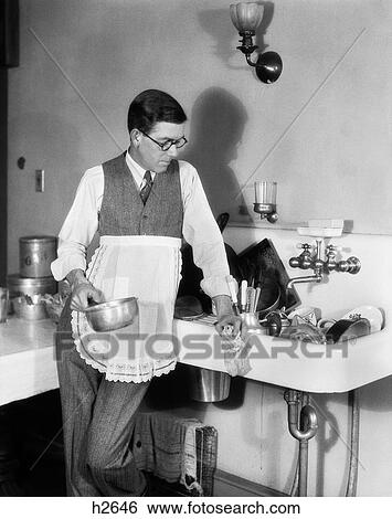 1920S Man In Apron Leaning On Sink Full Of Dirty Dishes Rag In One Hand Pot In Other View Large Photo Image Stock Photograph - 1920S Man In Apron Leaning On Sink Full Of Dirty Dishes Rag In One Hand Pot In Other. Fotosearch