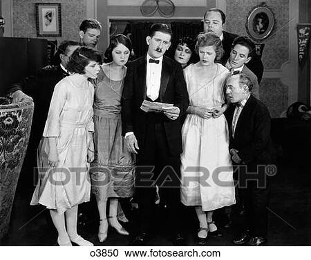 1920S Movie Still Man & Woman Group Around Man Reading Letter With Expression Of Worry Concern Or Sadness View Large Photo Image Stock Image - 1920S Movie Still Man & Woman Group Around Man Reading Letter With Expression Of Worry Concern Or Sadness . Fotosearch