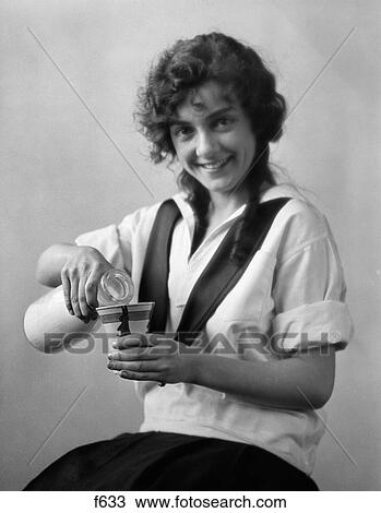 1920S Smiling Young Woman Sitting Pouring Milk From Bottle Into Cup Looking At Camera View Large Photo Image Stock Image - 1920S Smiling Young Woman Sitting Pouring Milk From Bottle Into Cup Looking At Camera. Fotosearch
