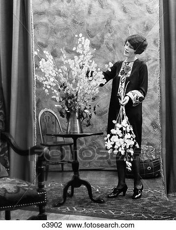1920S Woman Arranging Flowers In Aluminum Pitcher View Large Photo Image Stock Image - 1920S Woman Arranging Flowers In Aluminum Pitcher. Fotosearch