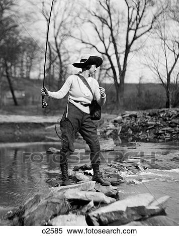 1920S Woman In Hat With Fishing Net & Tackle Bag Strapped To Her Casting Line Out Into Creek View Large Photo Image Stock Photography - 1920S Woman In Hat With Fishing Net & Tackle Bag Strapped To Her Casting Line Out Into Creek. Fotosearch