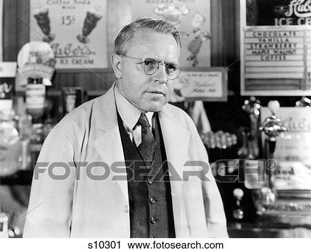 1930S 1940S Drug Store Soda Fountain Man Pharmacist Wearing White Coat And Glasses Listening View Large Photo Image Stock Image - 1930S 1940S Drug Store Soda Fountain Man Pharmacist Wearing White Coat And Glasses Listening. Fotosearch