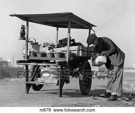 1930S 1940S Grocer Outdoors At Vegetable Cart View Large Photo Image Stock Photo - 1930S 1940S Grocer Outdoors At Vegetable Cart. Fotosearch