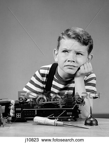 1930S 1940S Little Boy Thinking Or Worrying About Broken Lionel Electric Toy Train Engine View Large Photo Image Stock Image - 1930S 1940S Little Boy Thinking Or Worrying About Broken Lionel Electric Toy Train Engine. Fotosearch