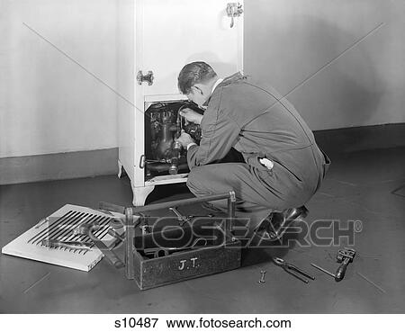 1930S 1940S Man Workman Fixing Refrigeration Machinery Of Refrigerator In Kitchen Repair Service View Large Photo Image Stock Photo - 1930S 1940S Man Workman Fixing Refrigeration Machinery Of Refrigerator In Kitchen Repair Service. Fotosearch