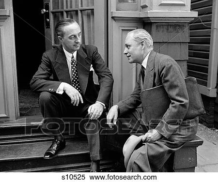 1930S 1940S Salesman And Home Owner Man Sitting Together On Front Stoop Talking Sales Presentation View Large Photo Image Stock Photography - 1930S 1940S Salesman And Home Owner Man Sitting Together On Front Stoop Talking Sales Presentation. Fotosearch