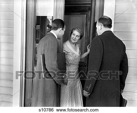 1930S 1940S Two Door-To-Door Sales Salesmen Talking To Housewife At Front Door Making Sales Presentation View Large Photo Image Stock Photograph - 1930S 1940S Two Door-To-Door Sales Salesmen Talking To Housewife At Front Door Making Sales Presentation. Fotosearch