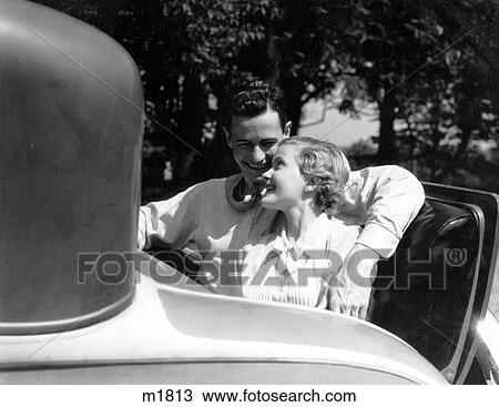 1930S Couple In Back Rumble Seat Rear Of Car Man With Arm Around Woman View Large Photo Image Stock Image - 1930S Couple In Back Rumble Seat Rear Of Car Man With Arm Around Woman . Fotosearch