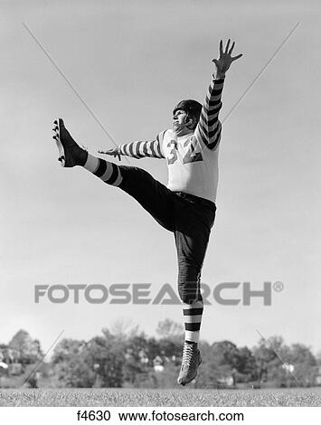1930S Football Kicker In Uniform With Striped Sleeves With Leg In Air & Other Foot Off Of Ground View Large Photo Image Stock Image - 1930S Football Kicker In Uniform With Striped Sleeves With Leg In Air & Other Foot Off Of Ground. Fotosearch