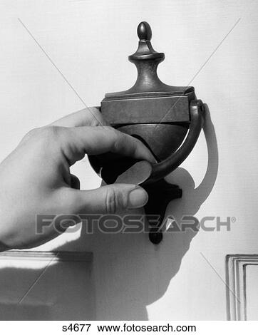 Stock Photo - 1930S Man'S Hand Lifting Door Knocker. Fotosearch