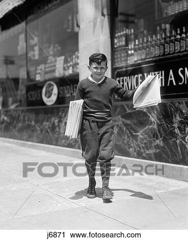 Stock Image - 1930S Newsboy In Knickers Walking Down Street Hawking Papers. Fotosearch