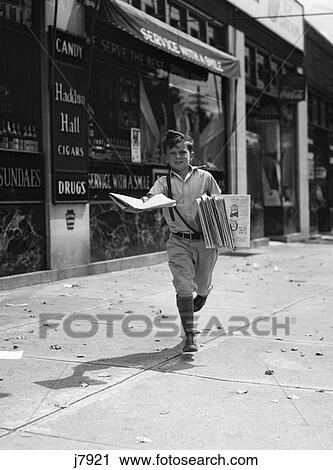 1930S Newspaper Boy In Knickers Walking Towards Camera On Street Holding Philadelphia Inquirer View Large Photo Image Stock Image - 1930S Newspaper Boy In Knickers Walking Towards Camera On Street Holding Philadelphia Inquirer . Fotosearch
