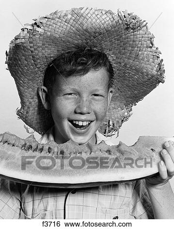 1940S 1950S Freckle-Faced Boy Wearing Straw Hat Eating Large Wedge Of Watermelon Looking At Camera View Large Photo Image Stock Photograph - 1940S 1950S Freckle-Faced Boy Wearing Straw Hat Eating Large Wedge Of Watermelon Looking At Camera. Fotosearch