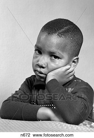 1940S 1950S Portrait Of Sad Unhappy African-American Boy Head Resting On Hand Looking At Camera View Large Photo Image Stock Image - 1940S 1950S Portrait Of Sad Unhappy African-American Boy Head Resting On Hand Looking At Camera. Fotosearch