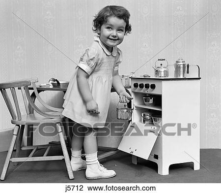 1940S 1950S Smiling Little Girl Taking Toy Pot Out Of Oven In Miniature Toy Cooking Stove View Large Photo Image Stock Image - 1940S 1950S Smiling Little Girl Taking Toy Pot Out Of Oven In Miniature Toy Cooking Stove. Fotosearch