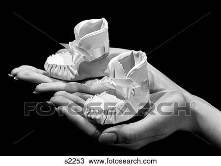 1940S 1950S Woman Mother Holding Baby Booties In Her Hands View Large Photo Image Stock Image - 1940S 1950S Woman Mother Holding Baby Booties In Her Hands. Fotosearch