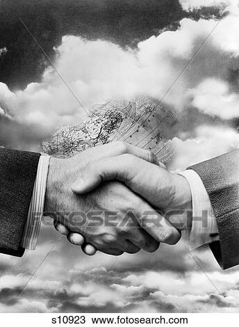Stock Image - 1940S Businessmen'S Hands In Handshake Superimposed On Background Of Globe Buried Among Clouds. Fotosearch