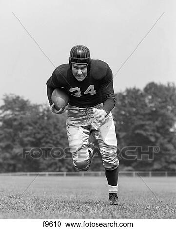 1940S Football Player Holding Football Running Forward Looking At Camera View Large Photo Image Stock Image - 1940S Football Player Holding Football Running Forward Looking At Camera. Fotosearch