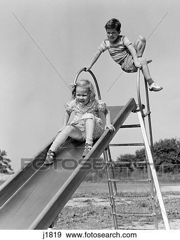 1940S Girl Going Down Slide Boy Waiting At Top View Large Photo Image Stock Photo - 1940S Girl Going Down Slide Boy Waiting At Top . Fotosearch