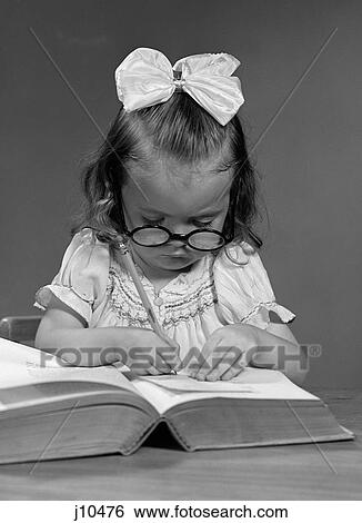 1940S Girl With Big Round Glasses And A Big White Ribbon Bow In Hair Copying From A Book With A Pencil View Large Photo Image Stock Photograph - 1940S Girl With Big Round Glasses And A Big White Ribbon Bow In Hair Copying From A Book With A Pencil . Fotosearch