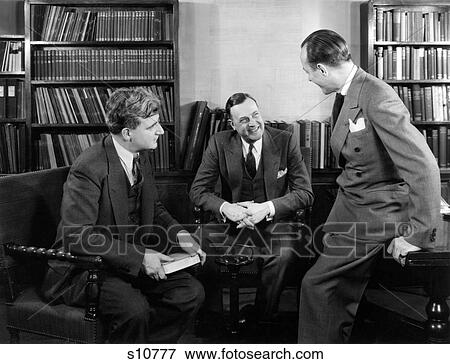 1940S Group Of Three Businessmen Sitting Together In Library Talking Smiling View Large Photo Image Stock Photo - 1940S Group Of Three Businessmen Sitting Together In Library Talking Smiling . Fotosearch
