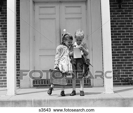 1940S Little Boy And Girl With School Bags Looking At Notepad Outdoor View Large Photo Image Stock Image - 1940S Little Boy And Girl With School Bags Looking At Notepad Outdoor. Fotosearch