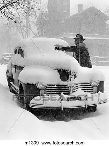 1940S Man Removing Snow From Windshield Of Parked Car View Large Photo Image Stock Photo - 1940S Man Removing Snow From Windshield Of Parked Car . Fotosearch