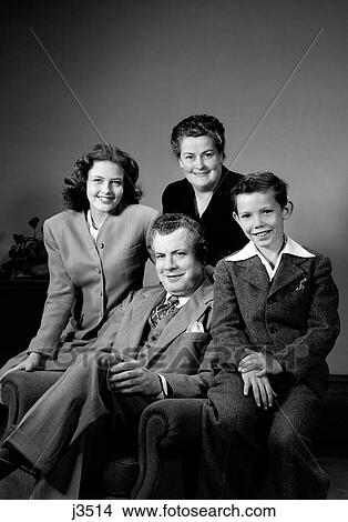 Picture - 1940S Portrait Family Mother Father Daughter Son Sitting Together On Chair Studio. Fotosearch