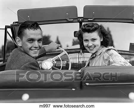 1940S Teenage Couple In Convertible Front Seat Turning To Look At Camera Smiling View Large Photo Image Stock Photo - 1940S Teenage Couple In Convertible Front Seat Turning To Look At Camera Smiling . Fotosearch
