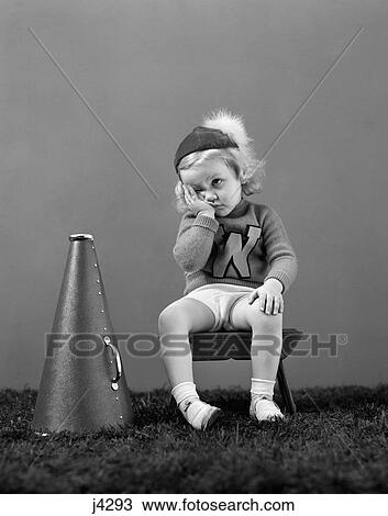 1940S Unhappy Little Girl Cheerleader Wearing A Cap And Varsity Sweater Frustrated Sad Look View Large Photo Image Stock Image - 1940S Unhappy Little Girl Cheerleader Wearing A Cap And Varsity Sweater Frustrated Sad Look . Fotosearch