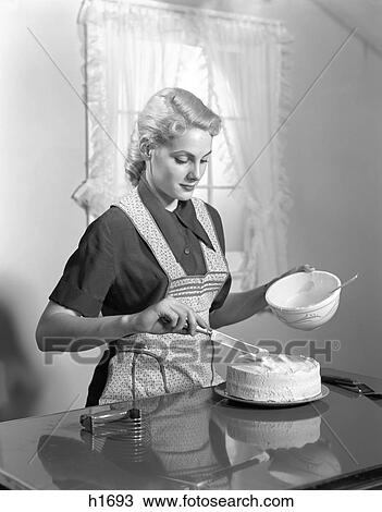 1940S Woman In Kitchen Wearing Apron Frosting Cake Indoor View Large Photo Image Stock Image - 1940S Woman In Kitchen Wearing Apron Frosting Cake Indoor. Fotosearch
