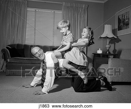 1950S 1960S Dad Carrying Boy & Girl Piggyback On Living Room Floor View Large Photo Image Stock Image - 1950S 1960S Dad Carrying Boy & Girl Piggyback On Living Room Floor. Fotosearch