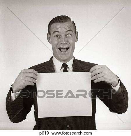 Stock Photo - 1950S 1960S Excited Businessman Looking At Camera Holding Blank White Card. Fotosearch