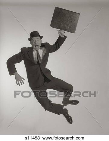1950S 1960S Excited Happy Businessman With Briefcase Jumping In Air Clicking Heels Together Looking At Camera Shouting View Large Photo Image Stock Photo - 1950S 1960S Excited Happy Businessman With Briefcase Jumping In Air Clicking Heels Together Looking At Camera Shouting. Fotosearch