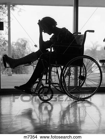 Picture - 1950S 1960S Silhouette Of Woman In Wheelchair With Leg Propped Up In Cast & Holding Hand On Forehead. Fotosearch
