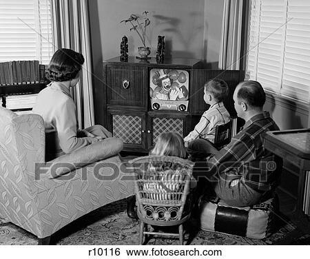1950S Back View Of Family Of 4 Gathered Around Tv Set Watching Clown With Balloons View Large Photo Image Stock Photograph - 1950S Back View Of Family Of 4 Gathered Around Tv Set Watching Clown With Balloons. Fotosearch