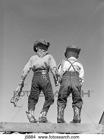 1950S Back View Of Two Boys Dressed In Cowboy Costume View Large Photo Image Picture - 1950S Back View Of Two Boys Dressed In Cowboy Costume. Fotosearch