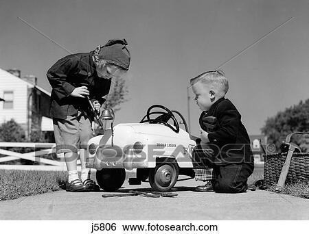 1950S Boy And Girl Playing At Repairing Toy Car View Large Photo Image Stock Photograph - 1950S Boy And Girl Playing At Repairing Toy Car . Fotosearch
