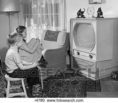 Stock Image - 1950S Boy And Girl Watching Tv In Living Room. Fotosearch