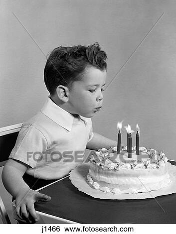 1950S Boy Four Years Old Blowing Out Candles On Birthday Cake Indoor View Large Photo Image Stock Photograph - 1950S Boy Four Years Old Blowing Out Candles On Birthday Cake Indoor. Fotosearch