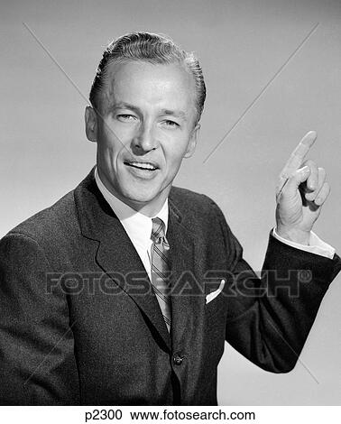 1950S Business Man Pointing With Left Hand Quizzical Expression Looking At Camera View Large Photo Image Stock Image - 1950S Business Man Pointing With Left Hand Quizzical Expression Looking At Camera. Fotosearch