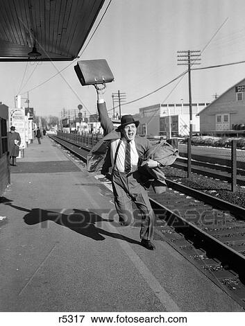 Stock Photo - 1950S Businessman With Briefcase In Air Running After Departing Train. Fotosearch