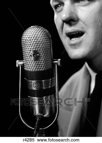 Stock Photography - 1950S Close-Up Of Man Announcer Talking Into Microphone Newscaster Indoor Symbolic Freedom Of Speech. Fotosearch