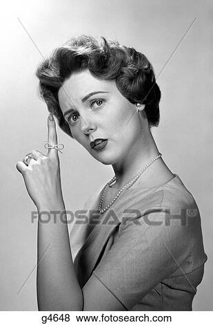 1950S Concerned Woman With Reminder String Knot Tied On Finger Of Hand To Help Remember Something Looking At Camera View Large Photo Image Stock Photo - 1950S Concerned Woman With Reminder String Knot Tied On Finger Of Hand To Help Remember Something Looking At Camera. Fotosearch