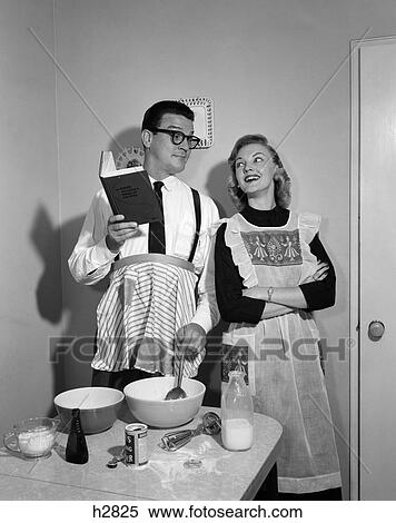 1950S Couple In Kitchen With Husband Learning To Cook While Wife Watches View Large Photo Image Stock Photography - 1950S Couple In Kitchen With Husband Learning To Cook While Wife Watches. Fotosearch