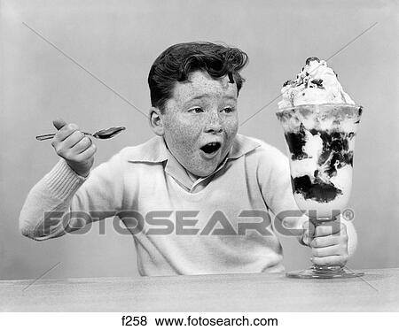 1950S Freckle Face Boy Digging Into Giant Ice Cream Sundae View Large Photo Image Stock Photo - 1950S Freckle Face Boy Digging Into Giant Ice Cream Sundae. Fotosearch