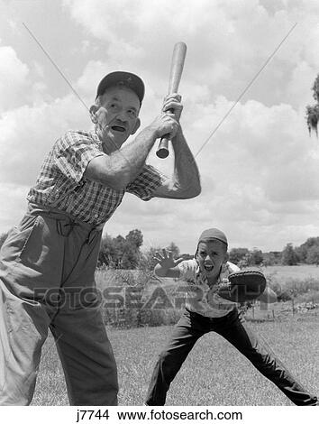 1950S Grandfather At Bat With Boy As Catcher Playing Baseball View Large Photo Image Picture - 1950S Grandfather At Bat With Boy As Catcher Playing Baseball. Fotosearch
