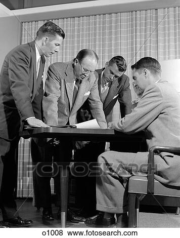 1950S Group Of Men Businessmen Looking At Plan On Desktop In Office Indoor View Large Photo Image Stock Photo - 1950S Group Of Men Businessmen Looking At Plan On Desktop In Office Indoor. Fotosearch