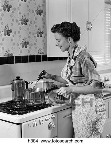 1950S Housewife In Apron Stirring Food In Saucepan On Stove View Large Photo Image Picture - 1950S Housewife In Apron Stirring Food In Saucepan On Stove. Fotosearch